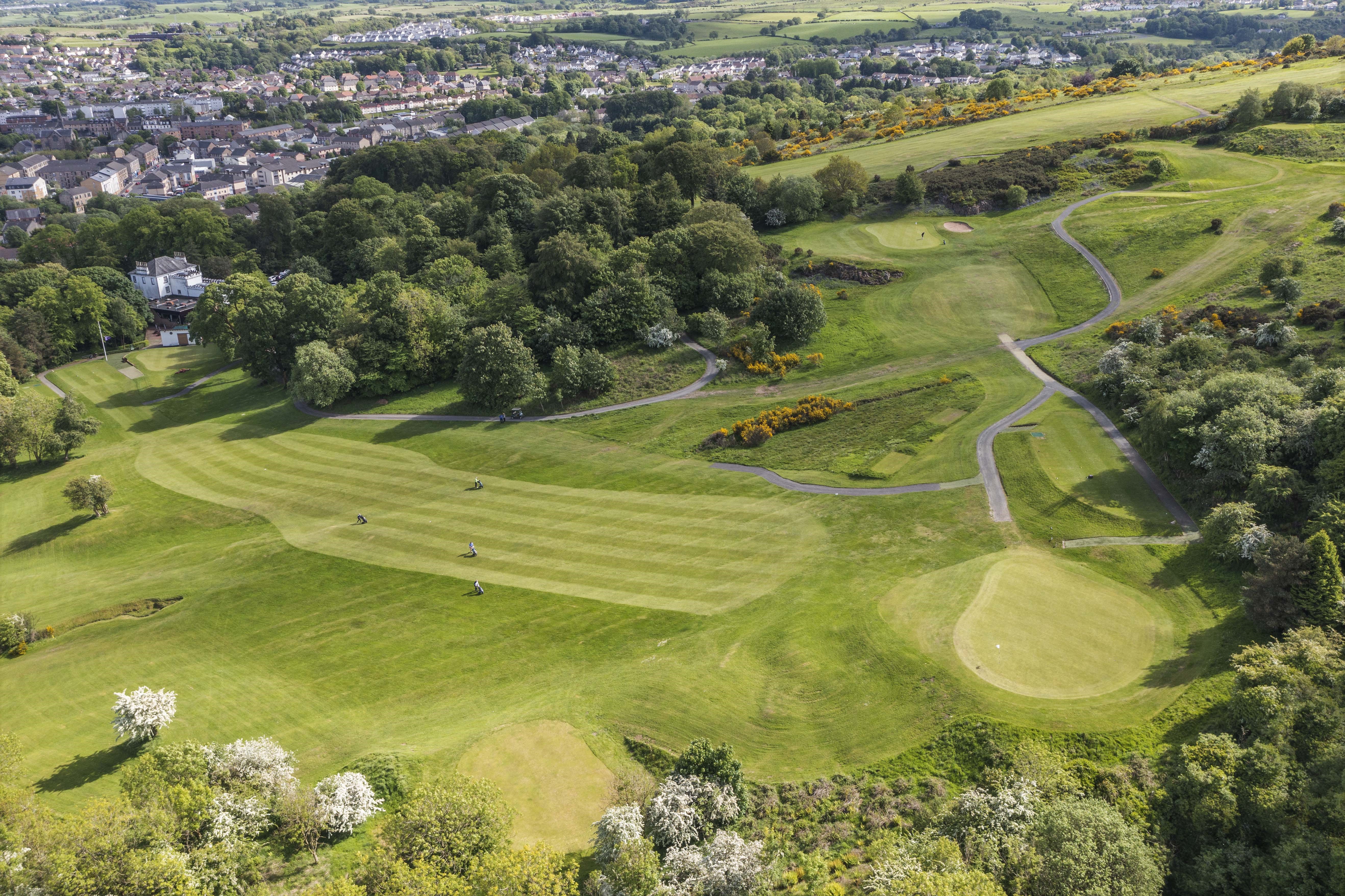 Image of golf ball on tee on grass.